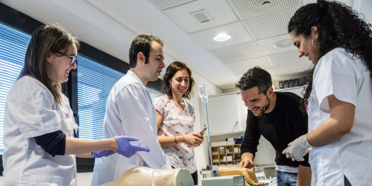 Estudiants i assistents a la celebració de la Diada de la Infermeria examinen material clínic als laboratoris de la Universitat d’Andorra.