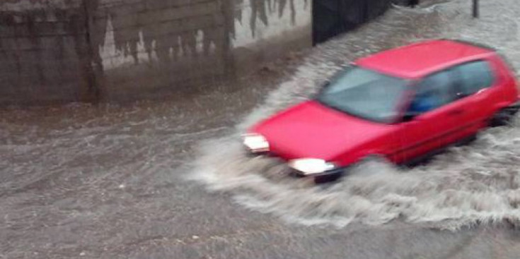 Un vehicle passa per una zona inundada, ahir a Santa Coloma.